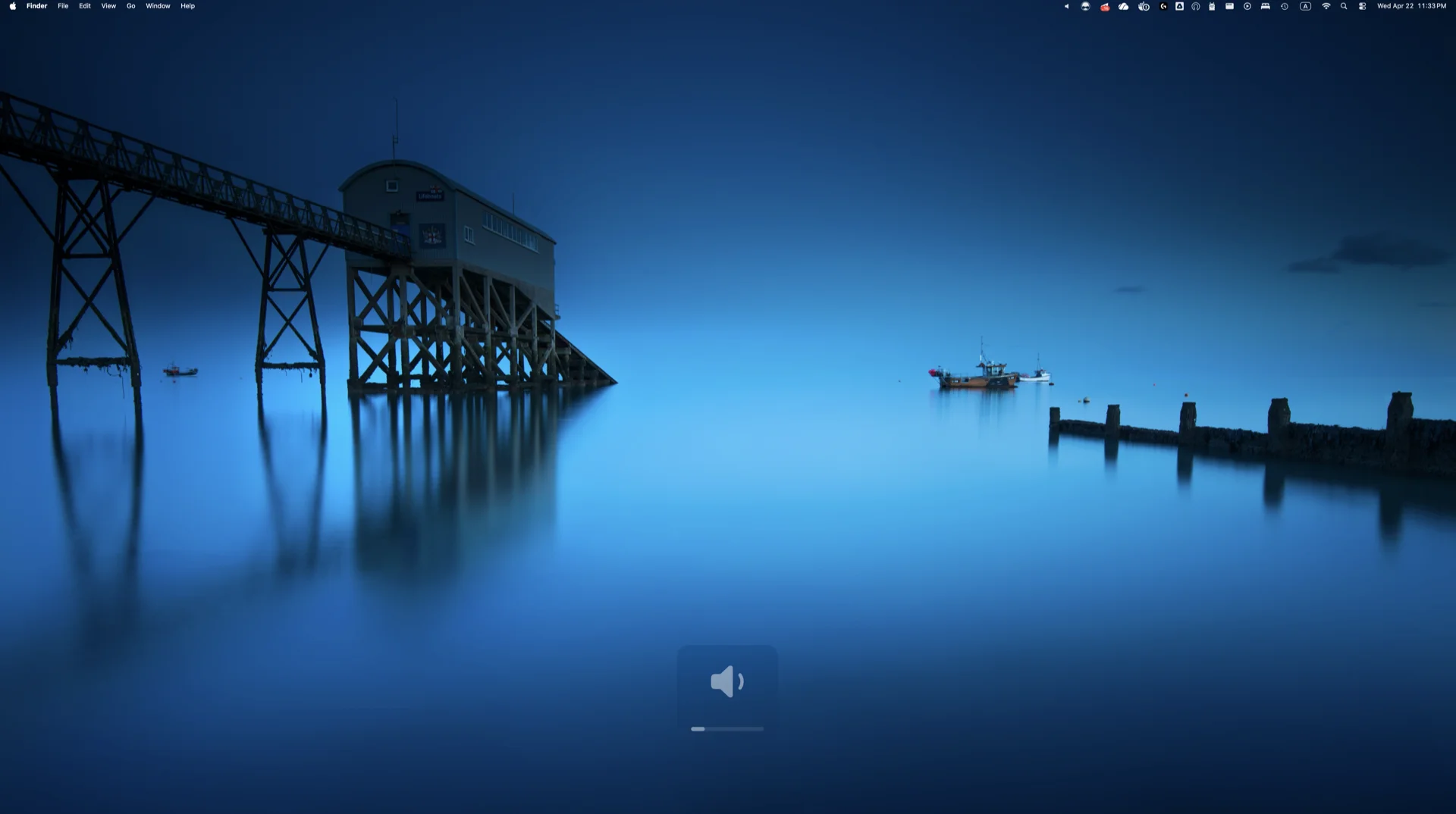 Halo's custom volume HUD showing a dark rounded panel with speaker icon and progress bar overlayed on a macOS desktop with a lifeboat station wallpaper